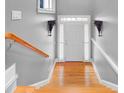 Bright hallway featuring hardwood steps, white trim, and elegant wall sconces at 195 Mystic Ct, Atlanta, GA 30342