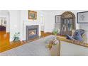 Elegant living room featuring a fireplace, hardwood floors, and classic display case at 195 Mystic Ct, Atlanta, GA 30342