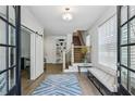Bright foyer featuring wood floors, barn door accent, and a staircase to the upper level at 2059 Wheaton Way, Atlanta, GA 30328