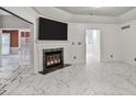Bright living room with marble floors, fireplace, and views to additional rooms at 2983 Crosswycke Forest Dr, Brookhaven, GA 30319