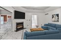 Bright living room featuring a fireplace with marble surround and a modern sectional sofa at 2983 Crosswycke Forest Dr, Brookhaven, GA 30319