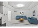 Bright living room features white marble floors, recessed lighting, and a comfortable blue sofa set at 2983 Crosswycke Forest Dr, Brookhaven, GA 30319