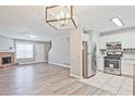 Inviting living room featuring a fireplace, wood floors, and lots of natural light coming from the window at 87 Davis Mill Ct, Lawrenceville, GA 30044
