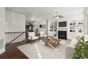 A bright living room with hardwood floors, a fireplace, and built-in bookshelves showcases a comfortable sitting area at 310 Rose Garden Ln, Alpharetta, GA 30009