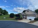 Inviting single-story home with lovely landscaping, driveway, and attached garage at 407 Aerif Place Pl, Woodstock, GA 30188