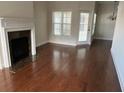 Elegant living room with hardwood floors, a fireplace, and lots of natural light at 407 Aerif Place Pl, Woodstock, GA 30188