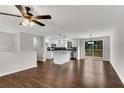 Bright open floor plan featuring wood floors, white kitchen with island, stainless appliances, and sliding door to deck at 3414 Dearwood Sw Dr, Lilburn, GA 30047