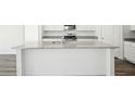 Well-lit kitchen featuring a central island with granite countertops and a stainless steel sink at 41 Bandimere Parkway, Dallas, GA 30157