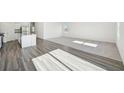 Bright living room with hardwood floors flowing to carpet and a view of the kitchen at 41 Bandimere Parkway, Dallas, GA 30157