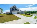 Two-story home showing the long driveway and spacious front yard at 4420 Merrigold Way, Fairburn, GA 30213