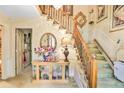 Elegant foyer with a staircase, decorative mirror, and display cabinet at 850 John Alden Rd, Stone Mountain, GA 30083