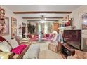 Spacious living room with exposed beams, comfortable seating, and a large television at 850 John Alden Rd, Stone Mountain, GA 30083