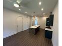 Bright kitchen and living area with stainless steel appliances, kitchen island, and open floor plan at 962 Bibbs Circle Nw # 6, Atlanta, GA 30318