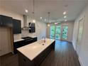 Contemporary kitchen featuring a large island, stainless steel appliances, and stylish pendant lighting at 962 Bibbs Circle Nw # 6, Atlanta, GA 30318