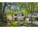 Charming two-story home with a brick foundation, a well-manicured lawn, carport, and mature trees at 1071 Standard Ne Dr, Brookhaven, GA 30319