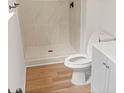 Updated bathroom with a tile shower, neutral colored floors, and a modern white vanity at 3735 Benchmark Dr, Atlanta, GA 30349