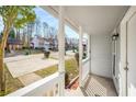 Cozy covered front porch with white columns, offering a welcoming view of the quiet neighborhood at 846 Brandy Oaks Ln, Stone Mountain, GA 30088