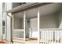 Covered front porch of a home featuring white railings, a white front door, and the house number at 846 Brandy Oaks Ln, Stone Mountain, GA 30088