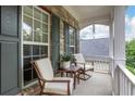 Relaxing front porch featuring comfortable seating and views of the surrounding neighborhood at 3980 Suwanee Place Dr, Suwanee, GA 30024