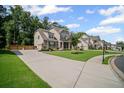 Well-maintained property featuring a long driveway and lush green lawn at 4960 Norman Ct, Cumming, GA 30040