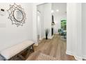 Stylish hallway featuring wood floors and leading into a comfortable and inviting living room at 8544 Plumtree Dr, Riverdale, GA 30274