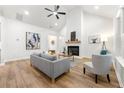 Cozy living room showcases modern decor, vaulted ceiling, hardwood floors, and lots of natural light at 8544 Plumtree Dr, Riverdale, GA 30274