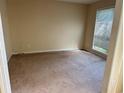Spacious bedroom with neutral walls and carpet, featuring a window providing natural light at 1570 Twin Bridge Ln, Lawrenceville, GA 30043
