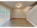 Bright living room features hardwood floors, recessed lighting, and a sliding glass door to the backyard at 1232 Pinedale Nw Cir, Conyers, GA 30012