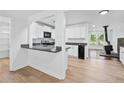 Bright kitchen with white cabinets, granite countertops, and a breakfast bar overlooking the living area at 1780 Penn Camp Road, Douglasville, GA 30134