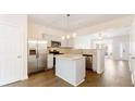 Modern kitchen with stainless steel appliances, a granite island, and ample lighting at 2727 Parkway Trl, Lithonia, GA 30058