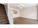Open-concept living room with hardwood floors and view of staircase and kitchen at 2727 Parkway Trl, Lithonia, GA 30058