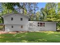 Inviting two-story home with a manicured lawn and classic white brick accents at 2984 E Paulding Dr, Dallas, GA 30157