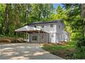 Two-story home featuring an attached covered parking area and lush green surroundings at 2984 E Paulding Dr, Dallas, GA 30157