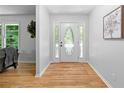 Bright foyer with hardwood floors and decorative front door featuring sidelights at 2984 E Paulding Dr, Dallas, GA 30157