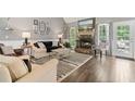 Cozy living room with stone fireplace, hardwood floors, and natural light at 7376 Bates Dr, Cumming, GA 30040