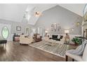 Spacious living room featuring vaulted ceilings, hardwood floors and lots of natural light at 7376 Bates Dr, Cumming, GA 30040