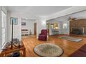 Open concept living room with hardwood floors, fireplace, and seamless flow to adjacent spaces at 8415 Ridge Rd, Fairburn, GA 30213