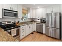 Modern kitchen with stainless steel appliances, granite counters, and ample cabinet space at 2164 Medfield Trl, Atlanta, GA 30345