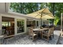 Outdoor patio with stamped concrete, large umbrella, and direct access to the dining room at 2164 Medfield Trl, Atlanta, GA 30345
