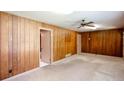 Living room featuring carpet flooring and wood paneled walls at 4545 Gaydon Rd, Powder Springs, GA 30127