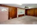 Living room with wood paneling, carpet flooring, and a ceiling fan at 4545 Gaydon Rd, Powder Springs, GA 30127