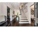 Inviting foyer with dark hardwood floors, a staircase with white risers, and access to other rooms at 615 Pinetree Dr, Decatur, GA 30030