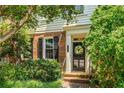 Attractive brick townhome featuring a decorative front door with a wreath, framed by manicured landscaping at 615 Pinetree Dr, Decatur, GA 30030