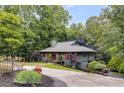 Beautiful two-story home with lush trees, modern architecture, and a spacious driveway at 921 Oak Dr, Woodstock, GA 30189