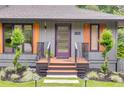 Modern home showcasing a front porch with custom railing, unique shutters and beautiful lighting at 921 Oak Dr, Woodstock, GA 30189