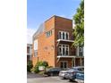 View of the brick exterior featuring balconies, multiple windows, and well-maintained landscaping at 1258 Dekalb Ne Ave # 112, Atlanta, GA 30307