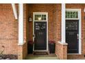 Charming front doors of townhomes, adorned with flower pots, and a brick facade at 1258 Dekalb Ne Ave # 112, Atlanta, GA 30307