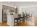Spacious kitchen with stainless steel appliances, gray cabinets, countertop dining, and eat-in dining area at 1258 Dekalb Ne Ave # 112, Atlanta, GA 30307