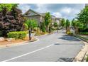 Gated entrance to a well-maintained community with lush landscaping and tree-lined streets at 2021 Towneship Trl, Roswell, GA 30075