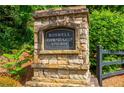 Stone sign for Roswell Township, established in 2016, surrounded by greenery at 2021 Towneship Trl, Roswell, GA 30075